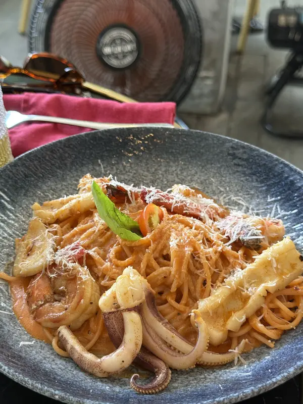 Seafood pasta with squid, shrimp and parmesan